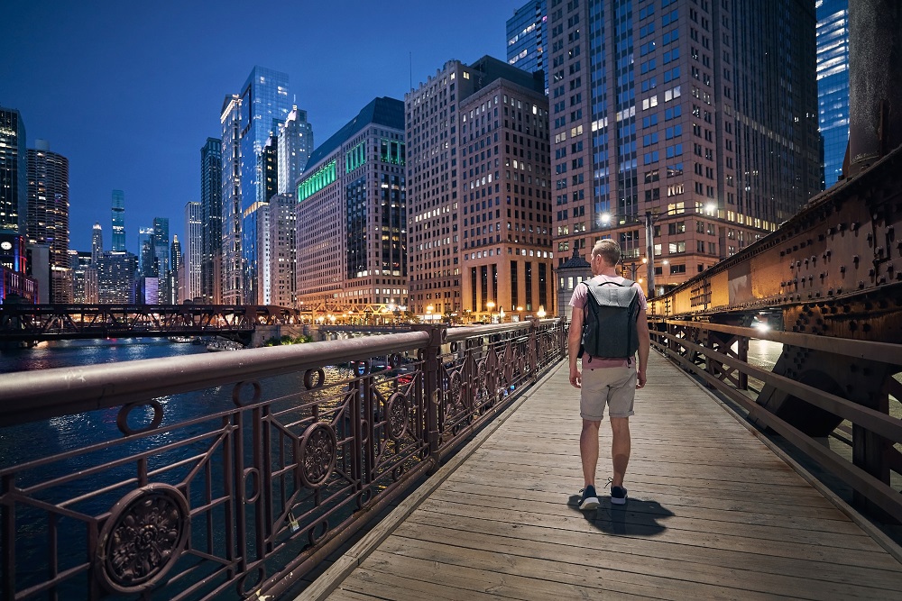 Man on Chicago river walk by night