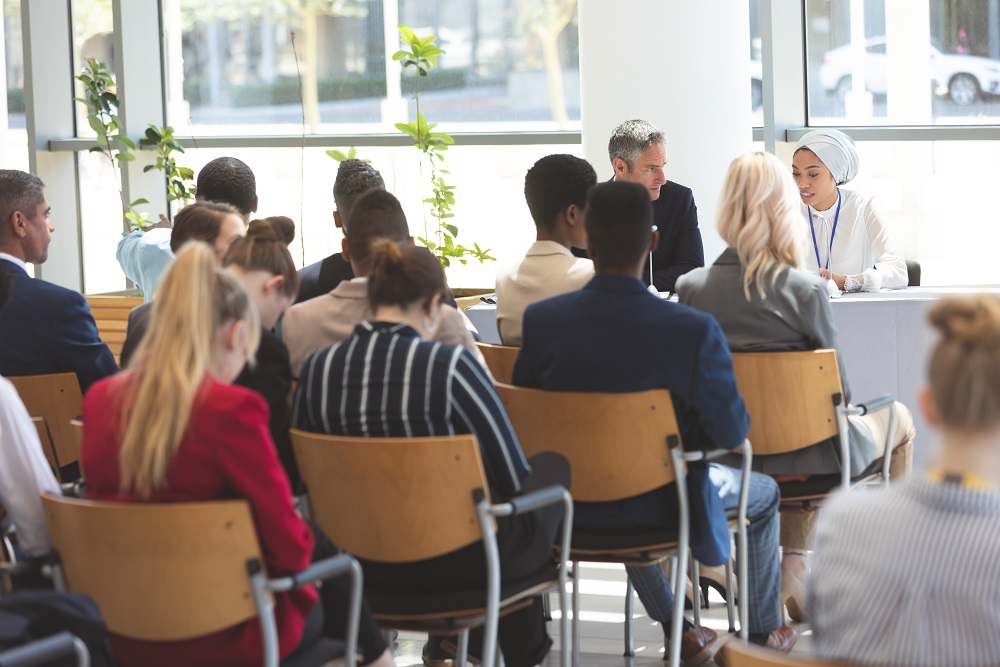 People seated in chairs attending a conference