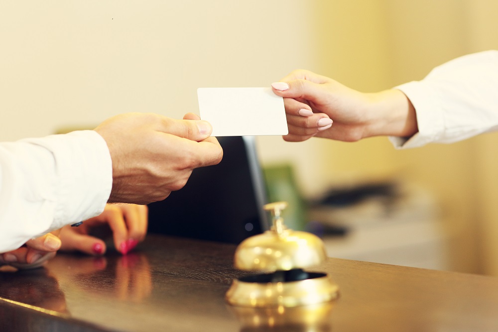 Receptionist giving loyalty card to rewards member