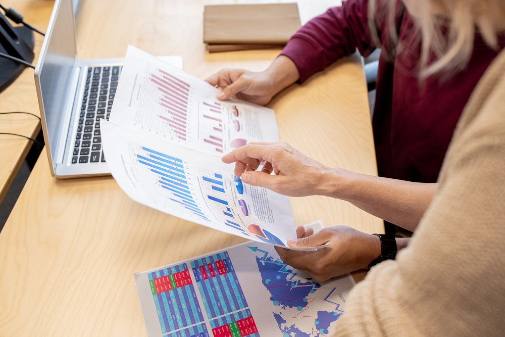 Two people working together to do financial analysis