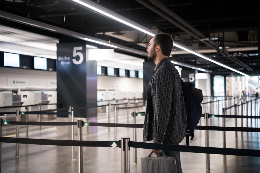 Man in airport security line with TSA precheck