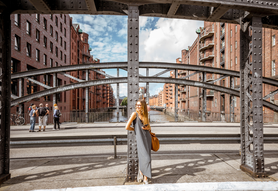 Business woman walking in Speicherstadt, historic warehouse district in Hamburg, Germany